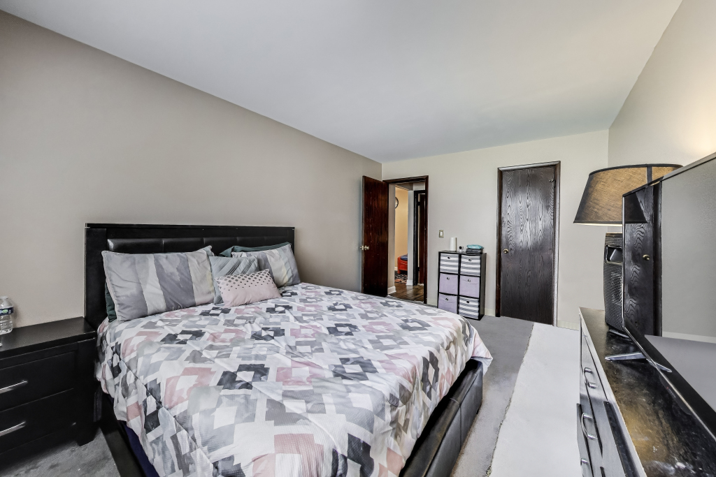 5113 North East River Road, Unit 1M Chicago, IL 60656 - Photo 23 of 25 a large bed sitting in a bedroom and a balcony
