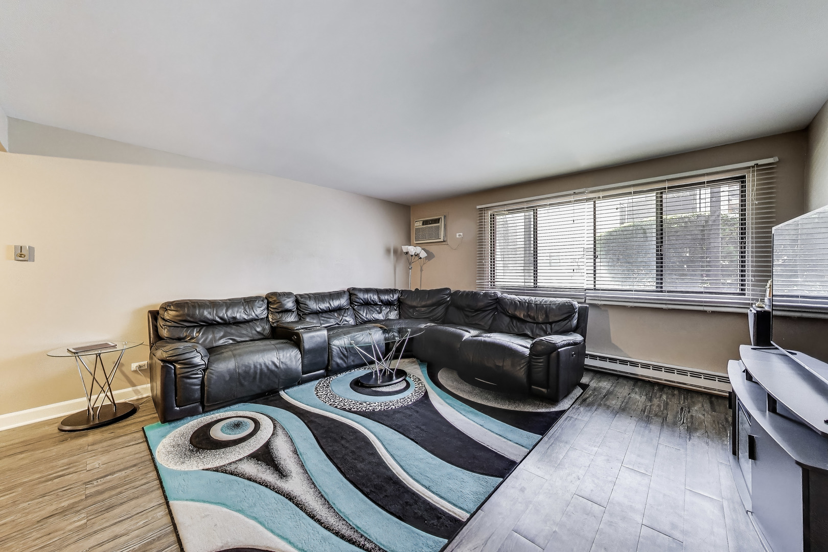 5113 North East River Road, Unit 1M Chicago, IL 60656 - Photo 7 of 25 a living room with furniture and a floor to ceiling window