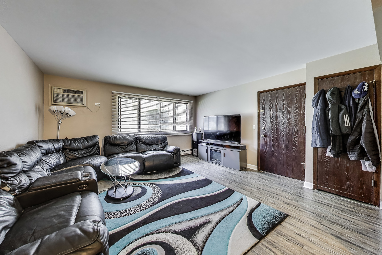 5113 North East River Road, Unit 1M Chicago, IL 60656 - Photo 8 of 25 a living room with furniture and a flat screen tv