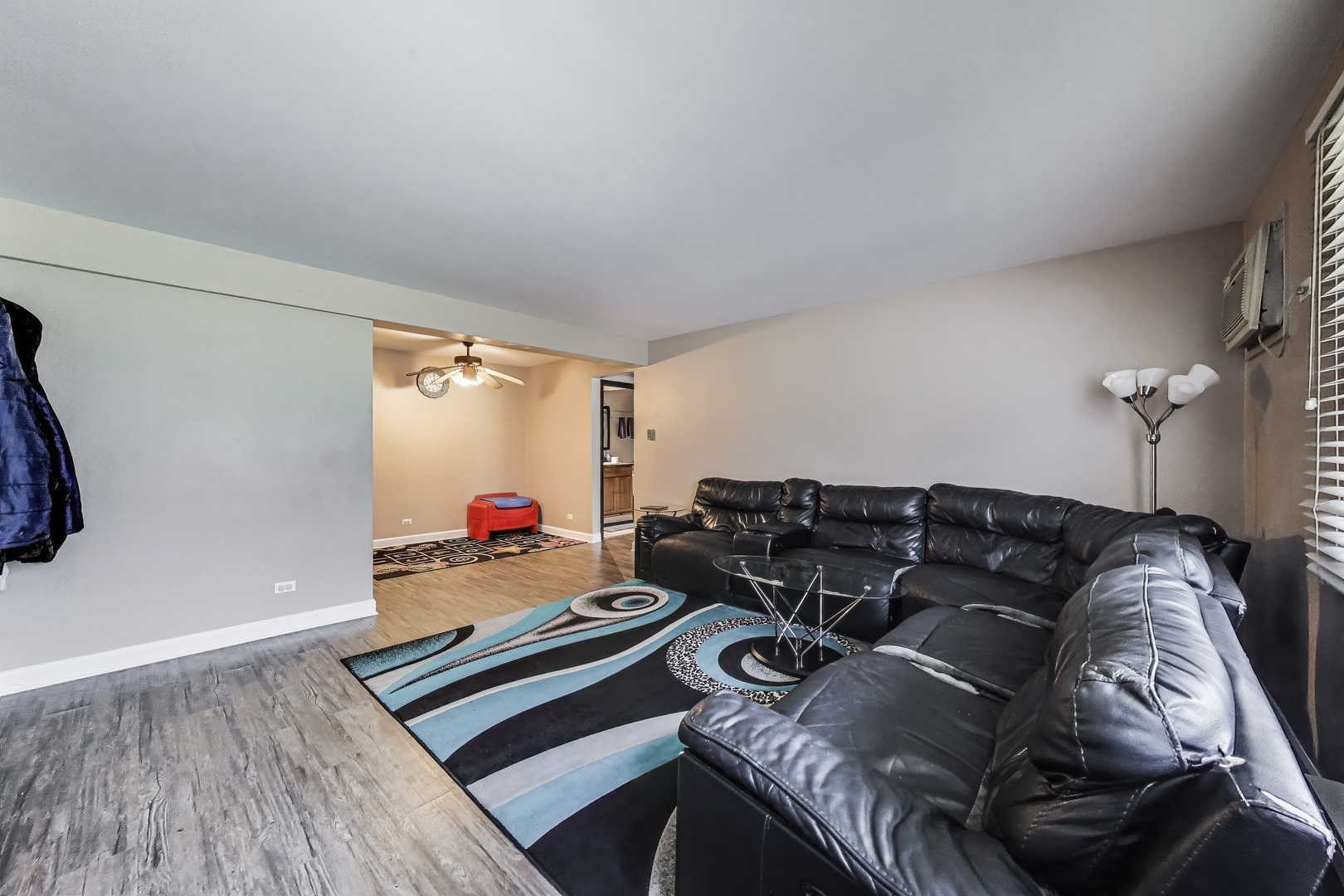 5113 North East River Road, Unit 1M Chicago, IL 60656 - Photo 9 of 25 a living room with furniture and a wooden floor