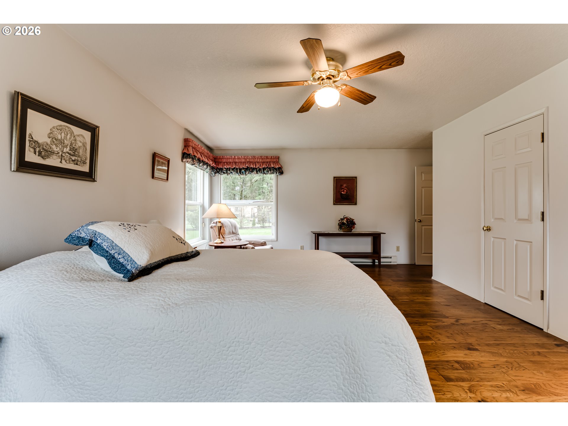 87919 Huston Road Veneta, OR 97487 - Photo 15 of 32 a bedroom with a large bed and a chandelier