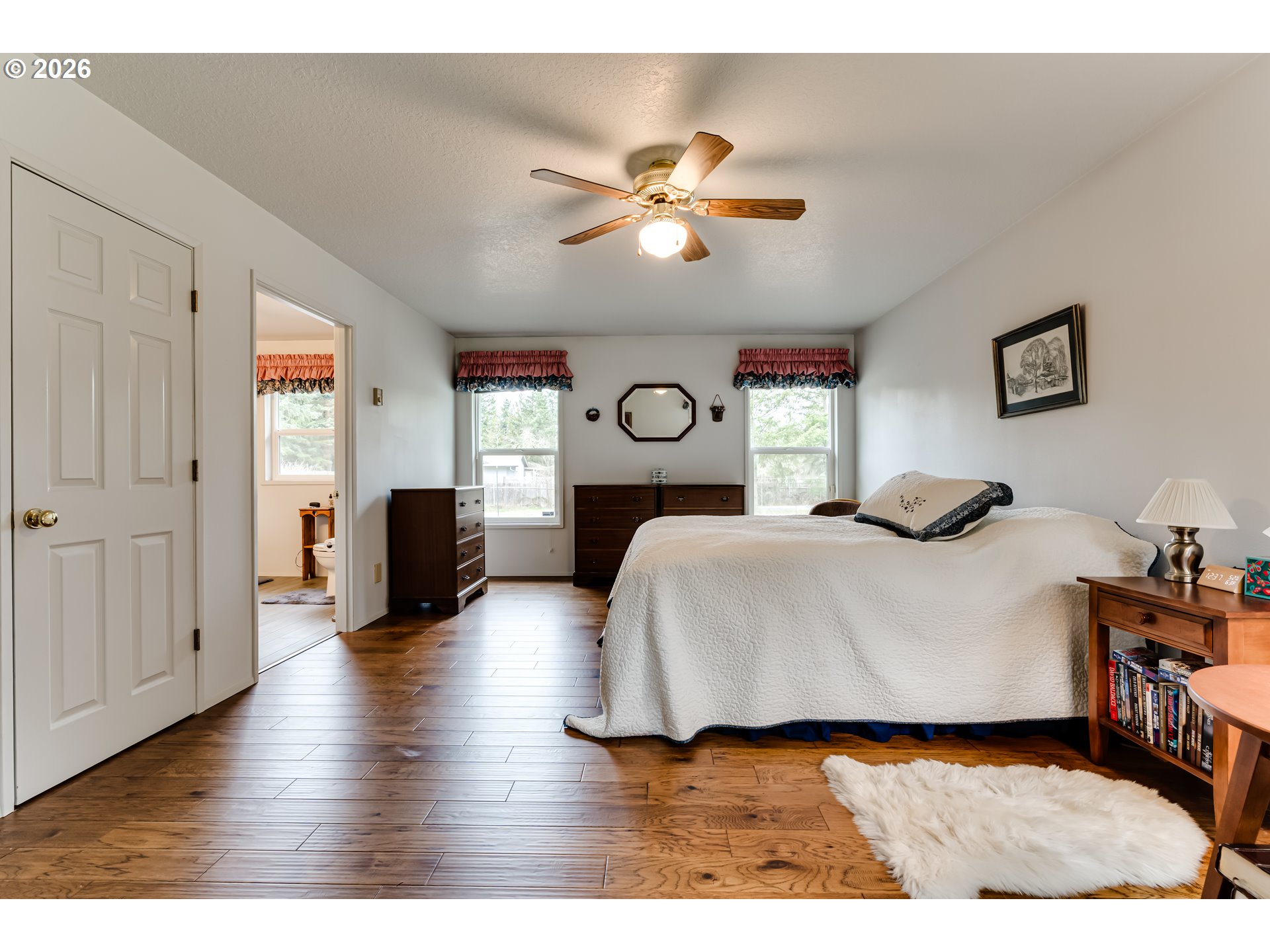87919 Huston Road Veneta, OR 97487 - Photo 16 of 32 a bedroom with a bed and wooden floor