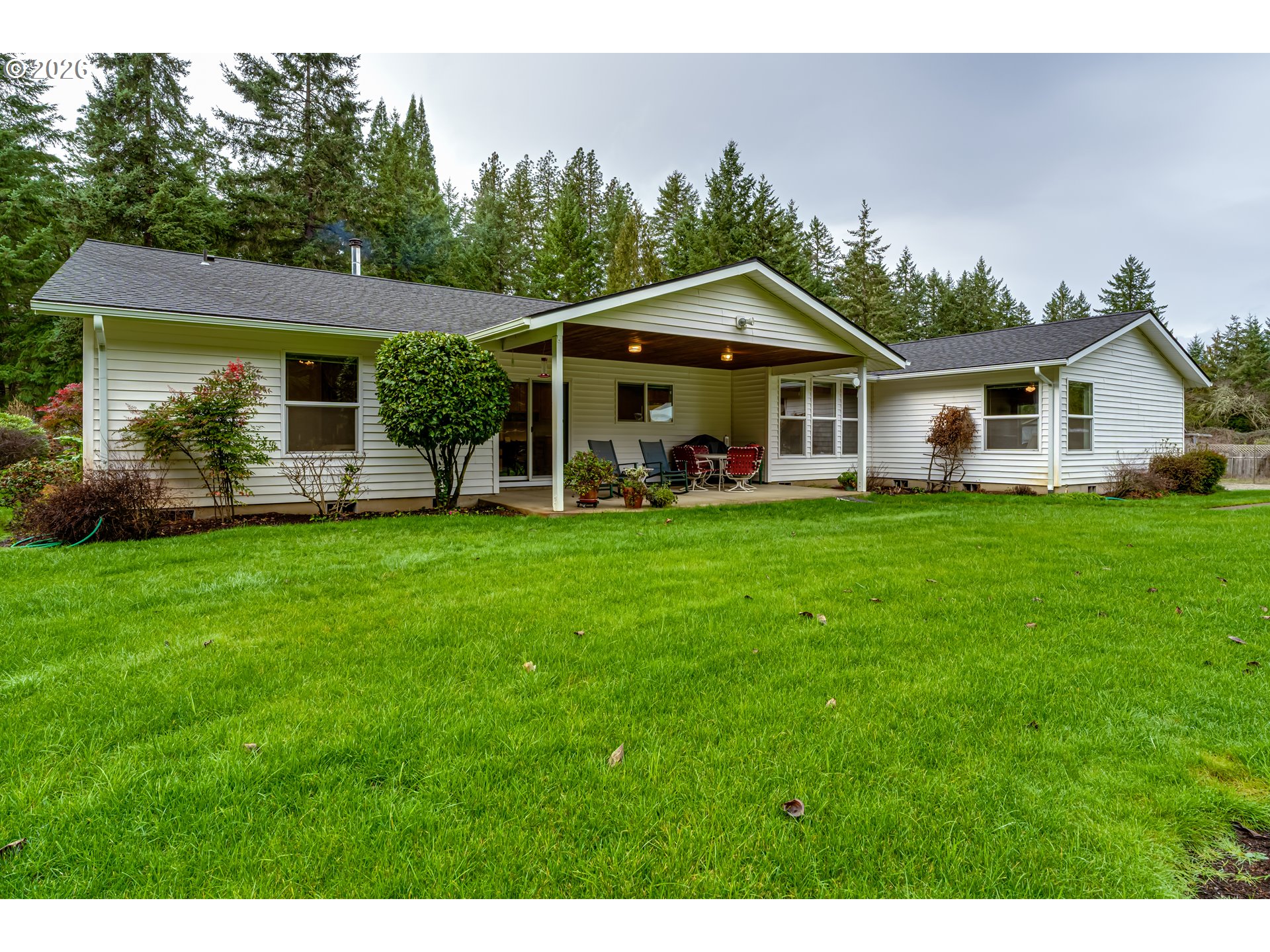 87919 Huston Road Veneta, OR 97487 - Photo 23 of 32 a view of a house with a yard and sitting area