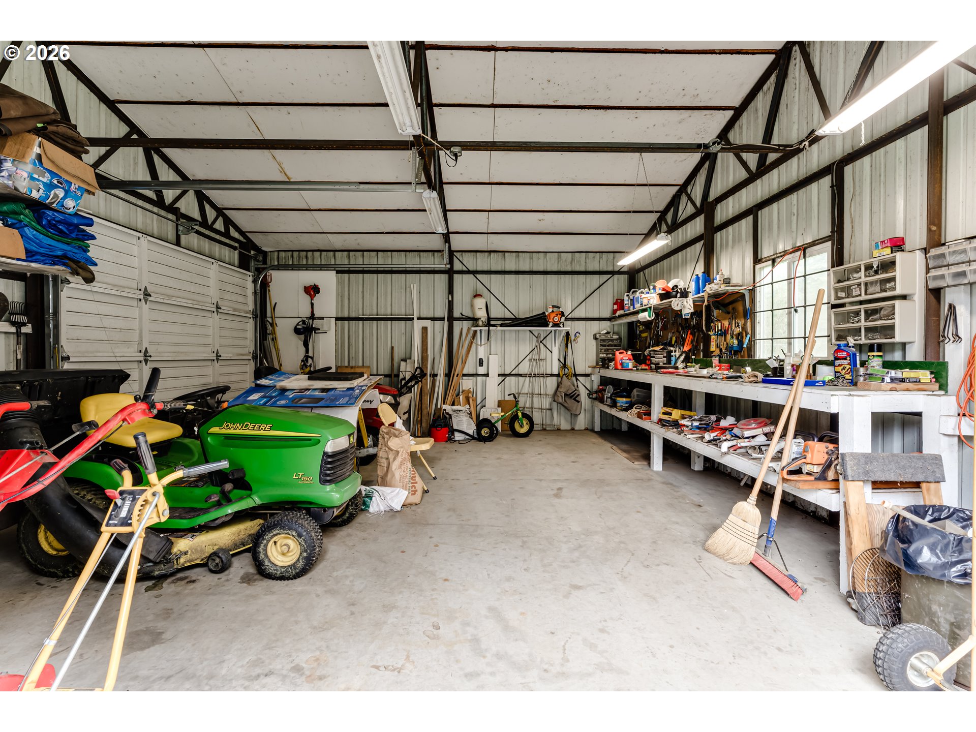 87919 Huston Road Veneta, OR 97487 - Photo 26 of 32 a view of a garage with a bike and wooden roof