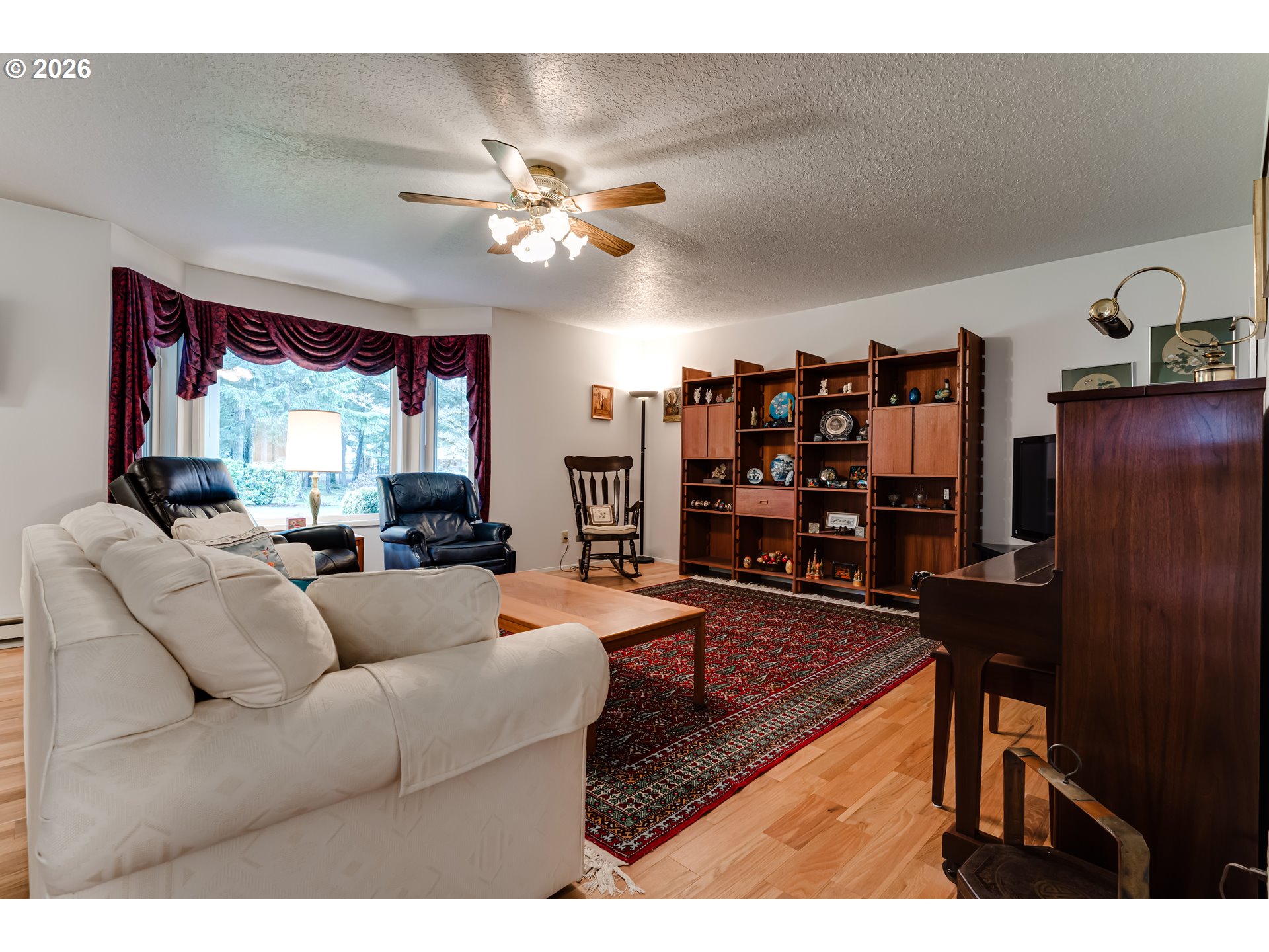 87919 Huston Road Veneta, OR 97487 - Photo 3 of 32 a living room with furniture a large window and bookshelf