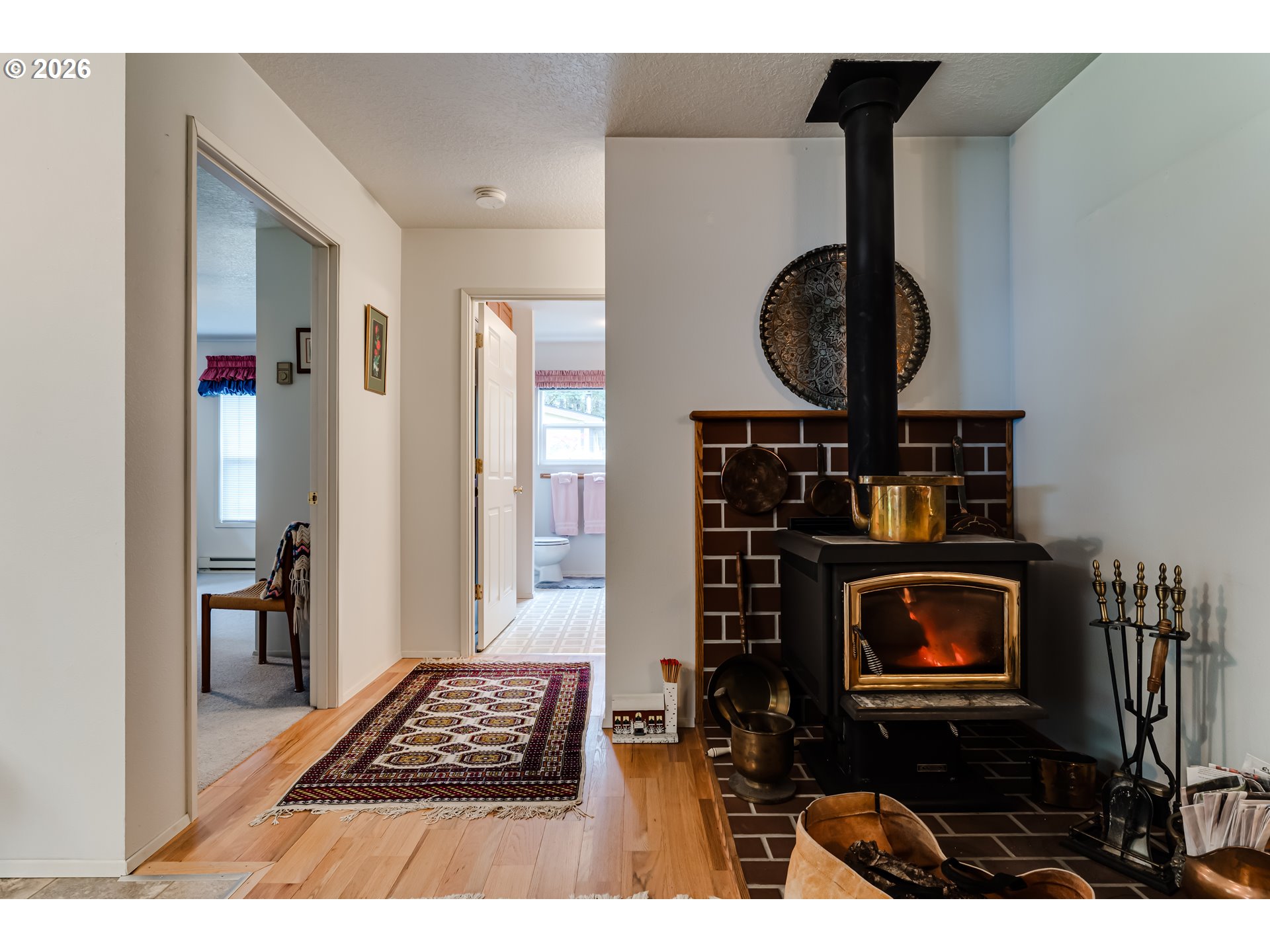 87919 Huston Road Veneta, OR 97487 - Photo 9 of 32 a picture of a room with a fireplace and cabinets