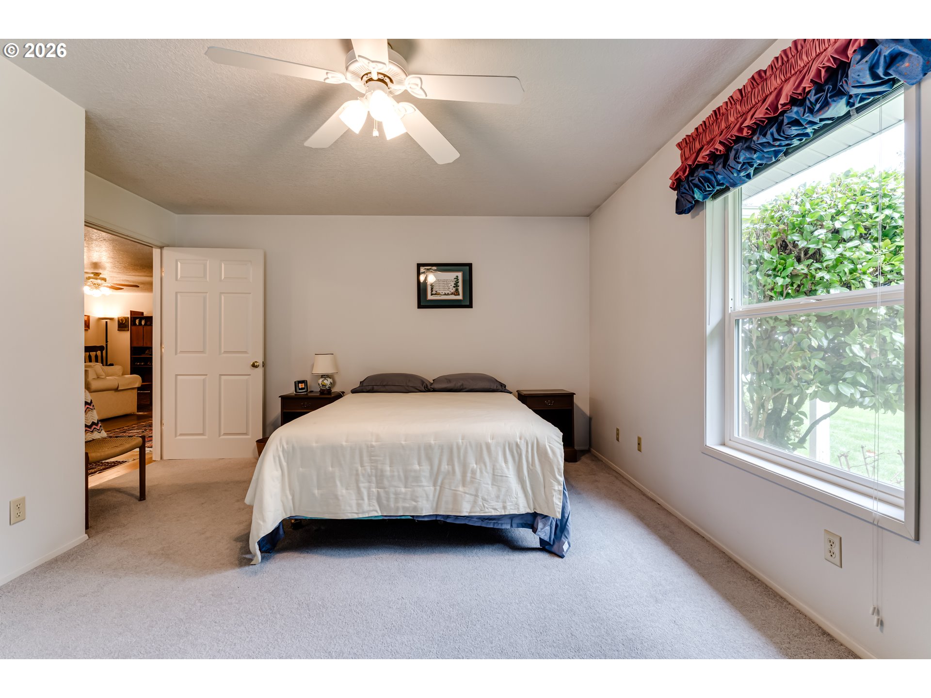 87919 Huston Road Veneta, OR 97487 - Photo 10 of 32 a spacious bedroom with a bed a chandelier and a window