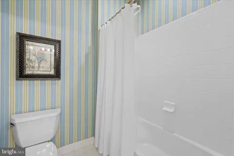 a view of a big house with a big yard and large trees