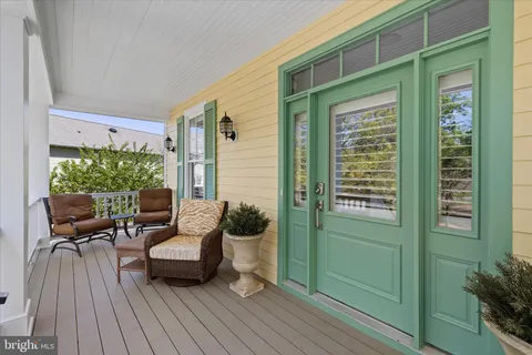 a living room with furniture and a book shelf