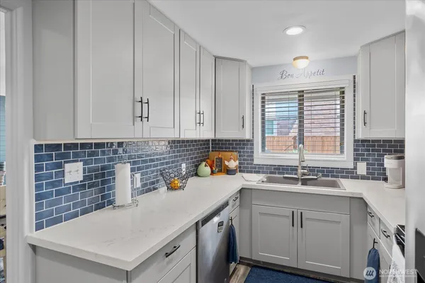 a kitchen with a sink cabinets and window