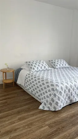 a view of a bedroom with furniture