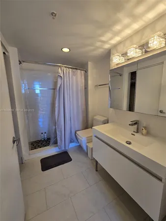 a bathroom with a double vanity sink and mirror