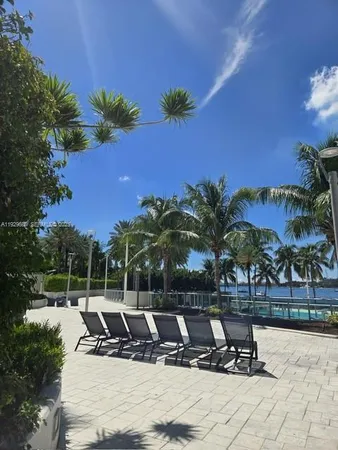 a view of a swimming pool with a table and chairs