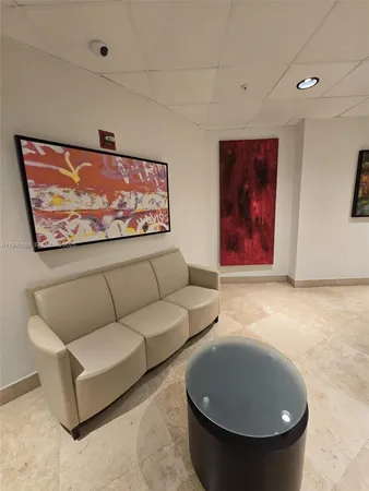 a living room with furniture and a air conditioner vent