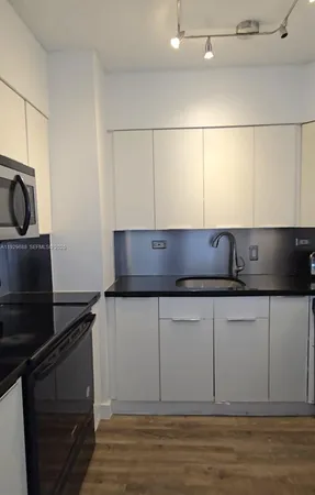 a kitchen with a sink and cabinets