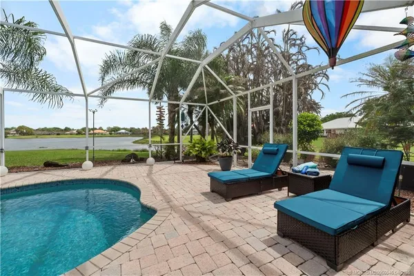 a view of a patio with couches chairs and a yard