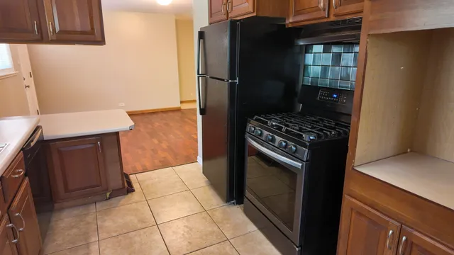 a kitchen with granite countertop a stove and a refrigerator