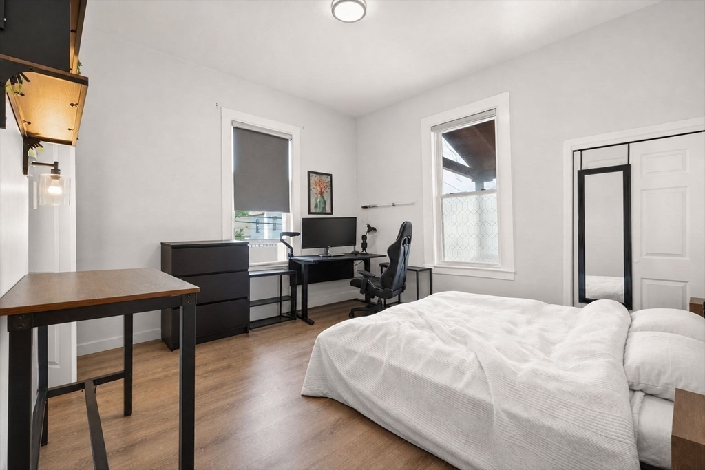 39 Union Street Boston, MA 02135 - Photo 19 of 33 a bedroom with a bed and wooden floor