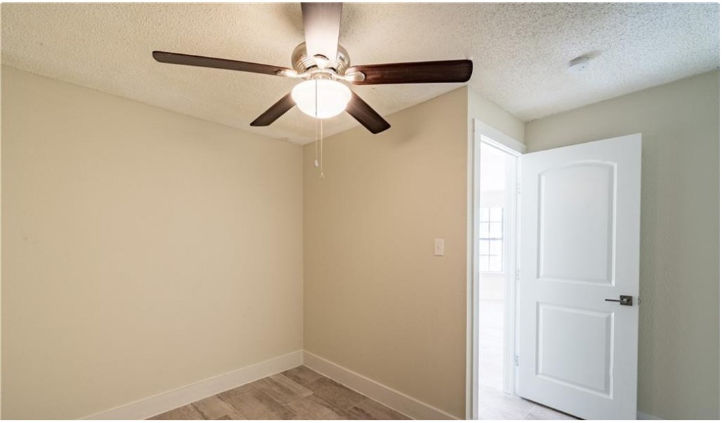 1412 Vargas Road, Unit B Austin, TX 78741 - Photo 4 of 10 a view of a hallway with a closet and a ceiling fan