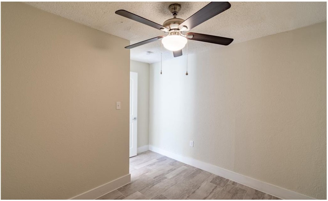 1412 Vargas Road, Unit B Austin, TX 78741 - Photo 5 of 10 an empty room with a fan and a fan