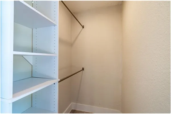 an empty room with a fan and a fan