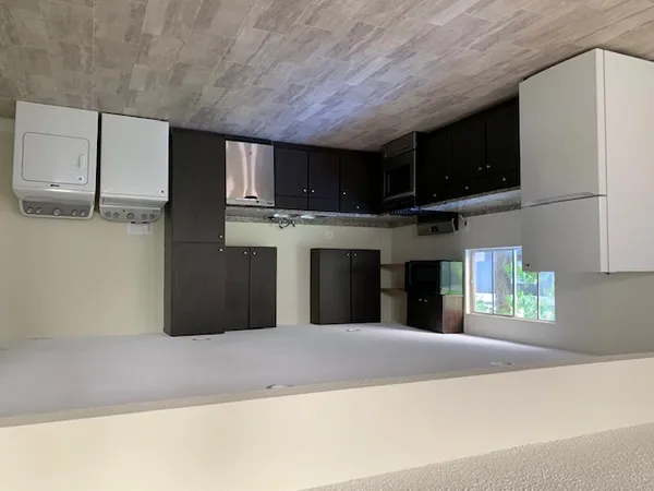 a large kitchen with a sink cabinets and stainless steel appliances