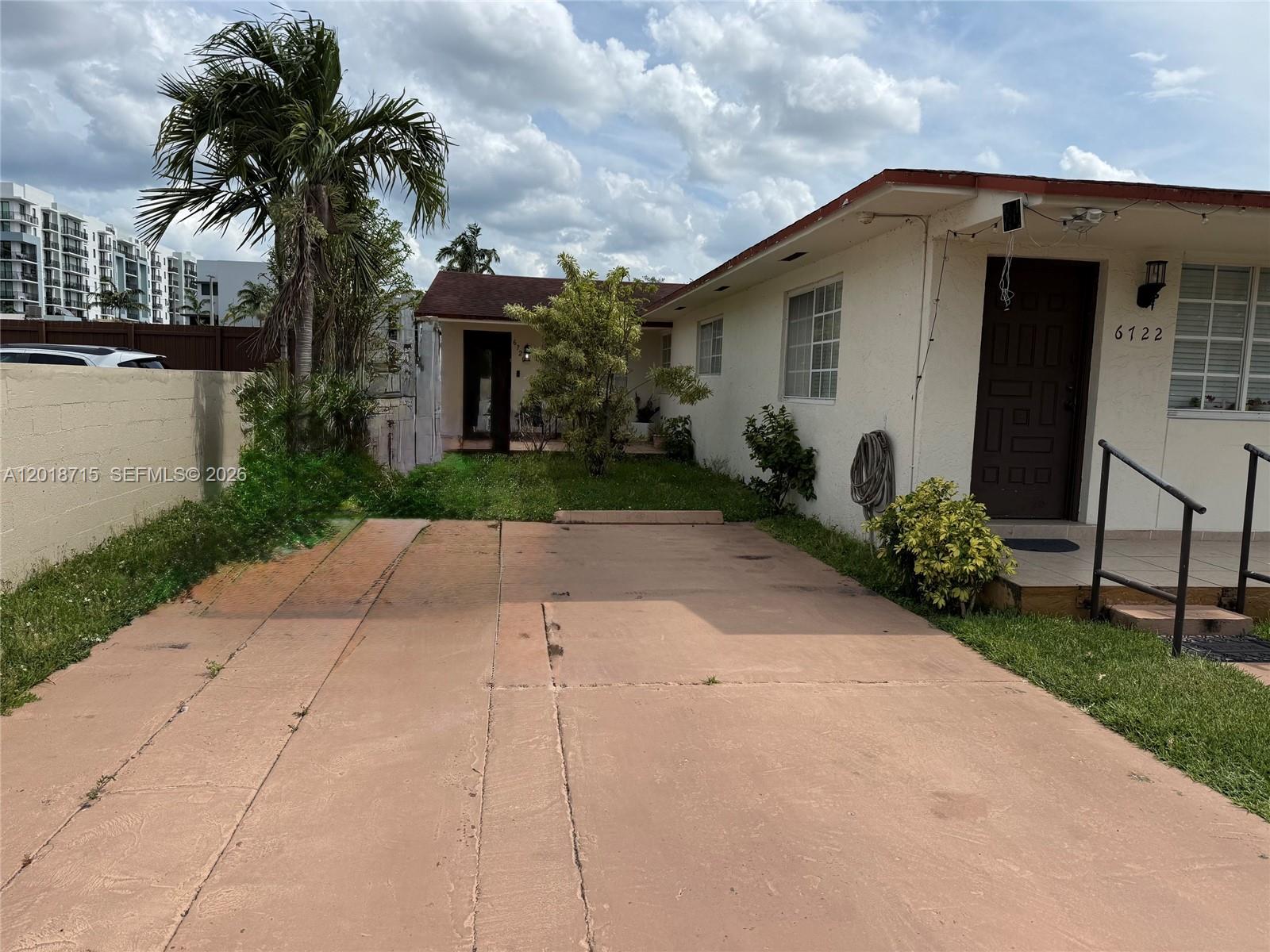 6720 Southwest 21st Street, Unit 1 Miami, FL 33155 - Photo 2 of 26 a front view of a house with garden