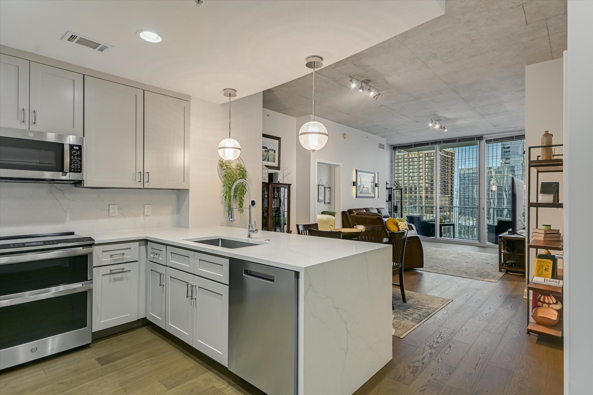 360 Nueces Street, Unit 1405 Austin, TX 78701 - Photo 7 of 40 a kitchen that has a lot of cabinets a sink and appliances in it
