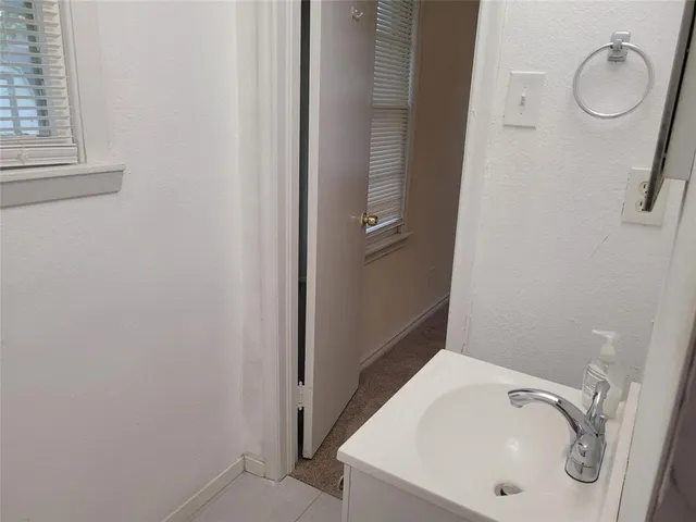 a bathroom with a sink and a window