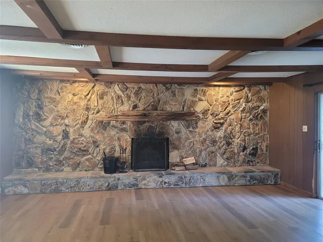 a view of a livingroom with wooden floor and a window
