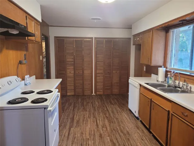 a kitchen that has a sink and a stove in it