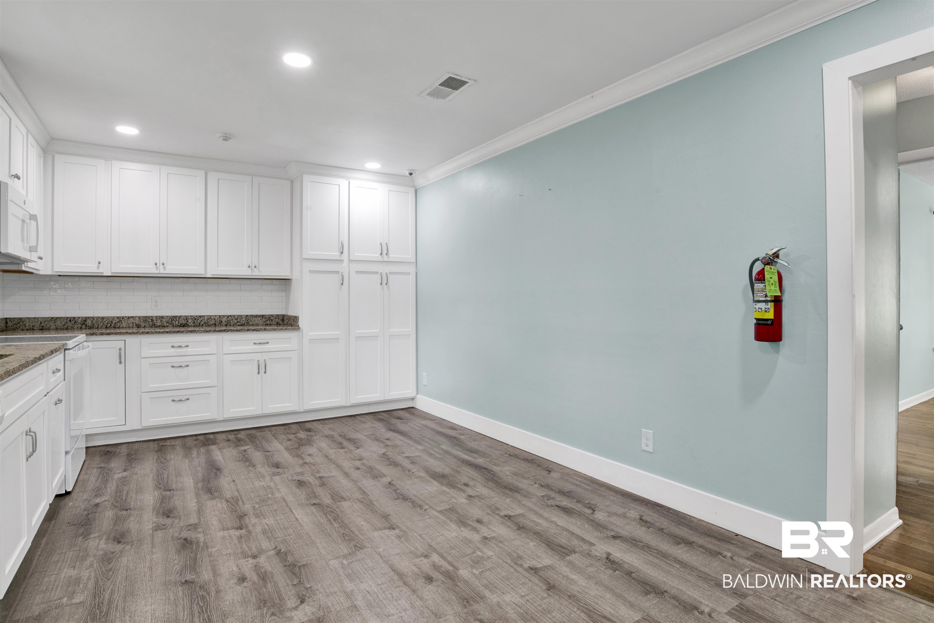 17714 Horseneck Road Bay Minette, AL 36507 - Photo 24 of 36 Full kitchen featuring white cabinetry, stone-finish countertops, and a white subway tile backsplash
