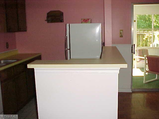 5747 Bramblegate Road, Unit G Greensboro, NC 27409 - Photo 8 of 14 Kitchen. High counter rim conceals kitchen clutter from dining area while preserving open feeling. In addition, it s the perfect spot to set up a buffet!