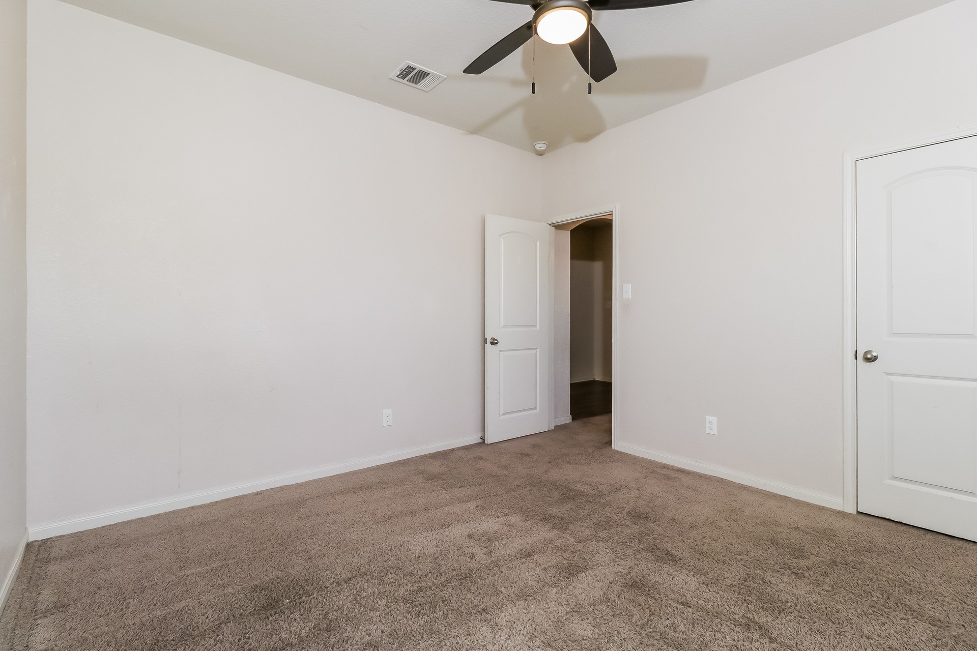 20017 Hubert R Humphrey Road Manor, TX 78653 - Photo 18 of 27 A well-lit bedroom features plush carpeting and a convenient ceiling fan.