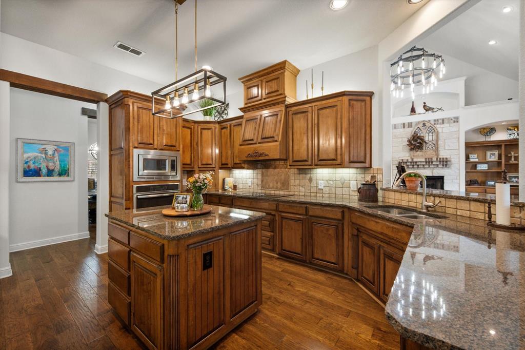 3840 Angela Court Midlothian, TX 76065 - Photo 13 of 40 a kitchen with stainless steel appliances granite countertop a stove a sink dishwasher and a refrigerator