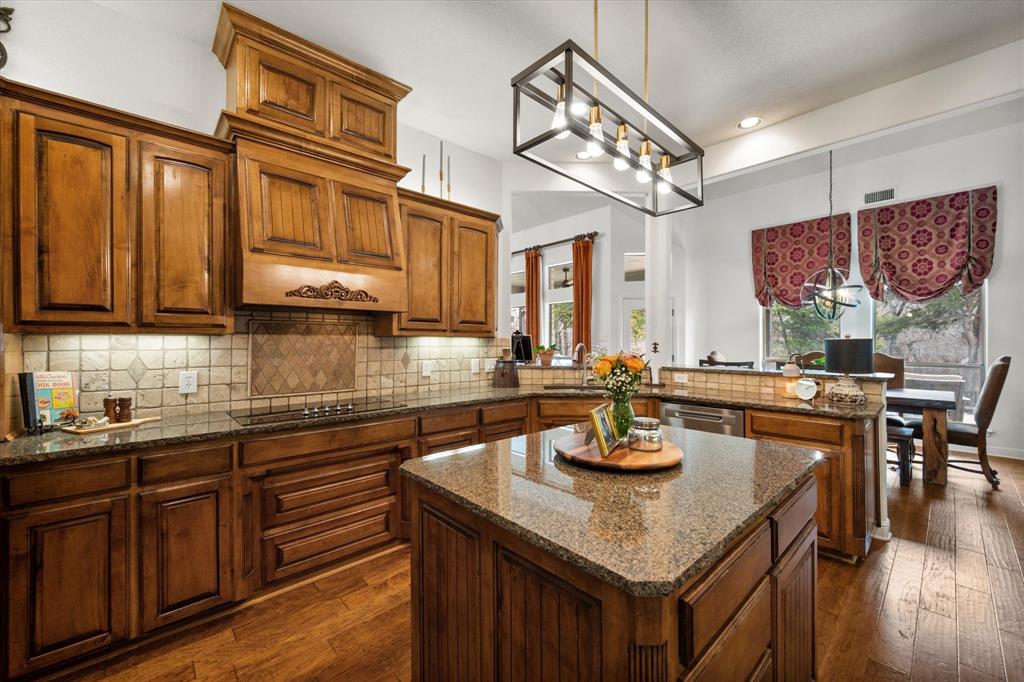 3840 Angela Court Midlothian, TX 76065 - Photo 14 of 40 a kitchen with stainless steel appliances granite countertop a sink a stove counter space and cabinets
