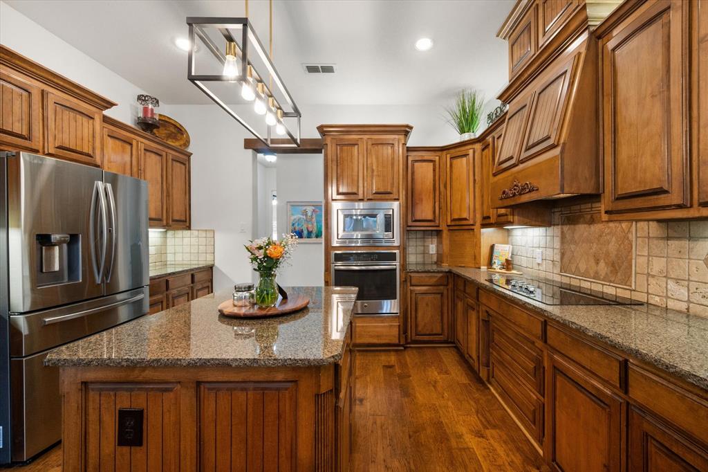 3840 Angela Court Midlothian, TX 76065 - Photo 15 of 40 a kitchen with stainless steel appliances granite countertop a refrigerator a stove and a sink