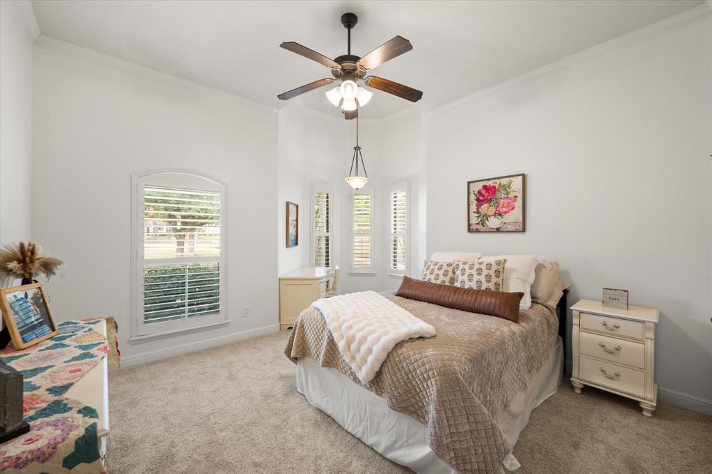 3840 Angela Court Midlothian, TX 76065 - Photo 24 of 40 a bedroom with a bed and a chandelier