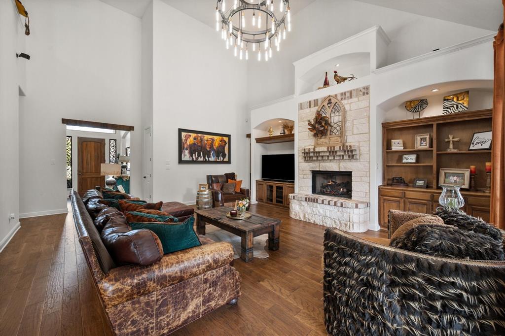 3840 Angela Court Midlothian, TX 76065 - Photo 10 of 40 a living room with furniture a flat screen tv and a fireplace