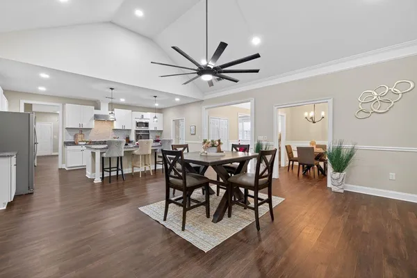 a view of a dining room with furniture and wooden floor