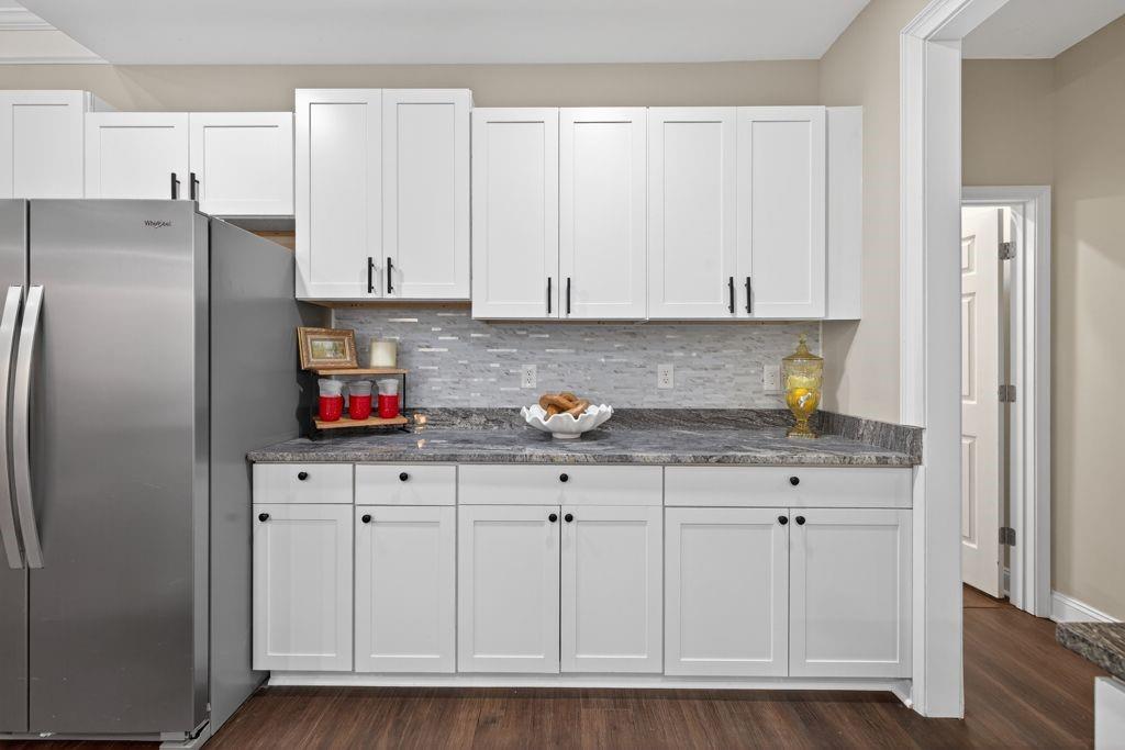 338 Mt Zion Road Oxford, GA 30054 - Photo 13 of 33 a kitchen with stainless steel appliances granite countertop a refrigerator a stove and white cabinets