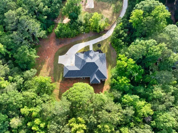 an aerial view of a house with a yard and garden