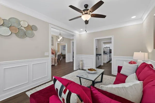 a living room with furniture and wooden floor