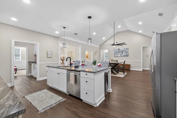 a kitchen with sink stove and view living room
