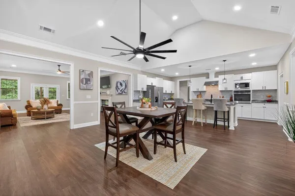 a view of a dining area with furniture and wooden floor