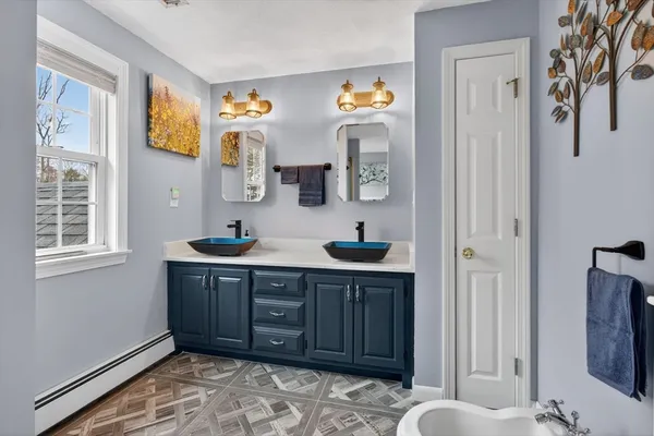 a spacious bathroom with a sink and a mirror