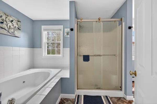 a bathroom with a tub shower and a sink