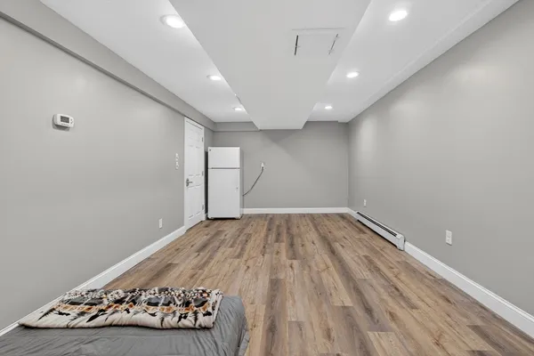 a view of a hallway with wooden floor and closet area