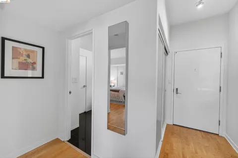 a bedroom with a bed and painting on the wall