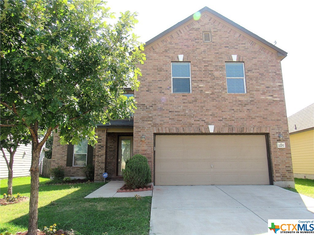 2207 Howry Drive Georgetown, TX 78626 - Photo 1 of 1 a front view of a house with a garden and yard